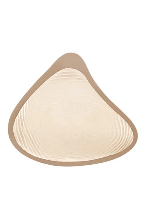 An Amoena breast form seen from the back, the side that rests against the skin