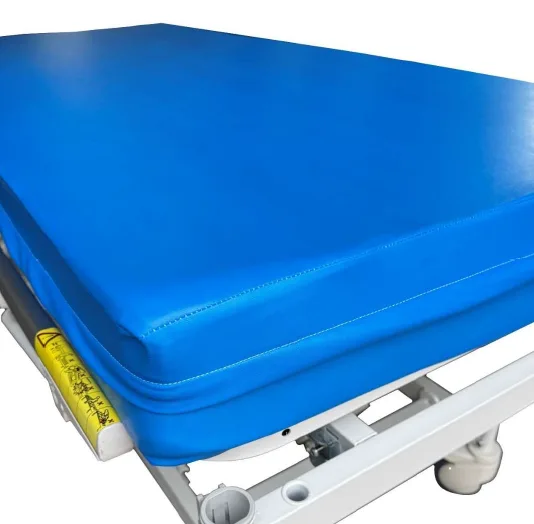 A hospital bed mattress in a blue wipe-clean cover