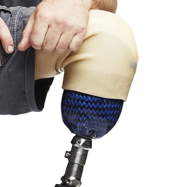ST&G Eclipse suspension sleeve rolled over a knee onto a blue carbon socket